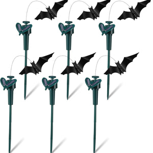 Set of Halloween bat decorations on sticks against a white background