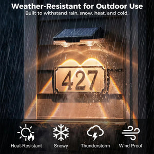 Solar-powered outdoor light with house number '427' in a rainstorm, highlighting weather-resistance features.
