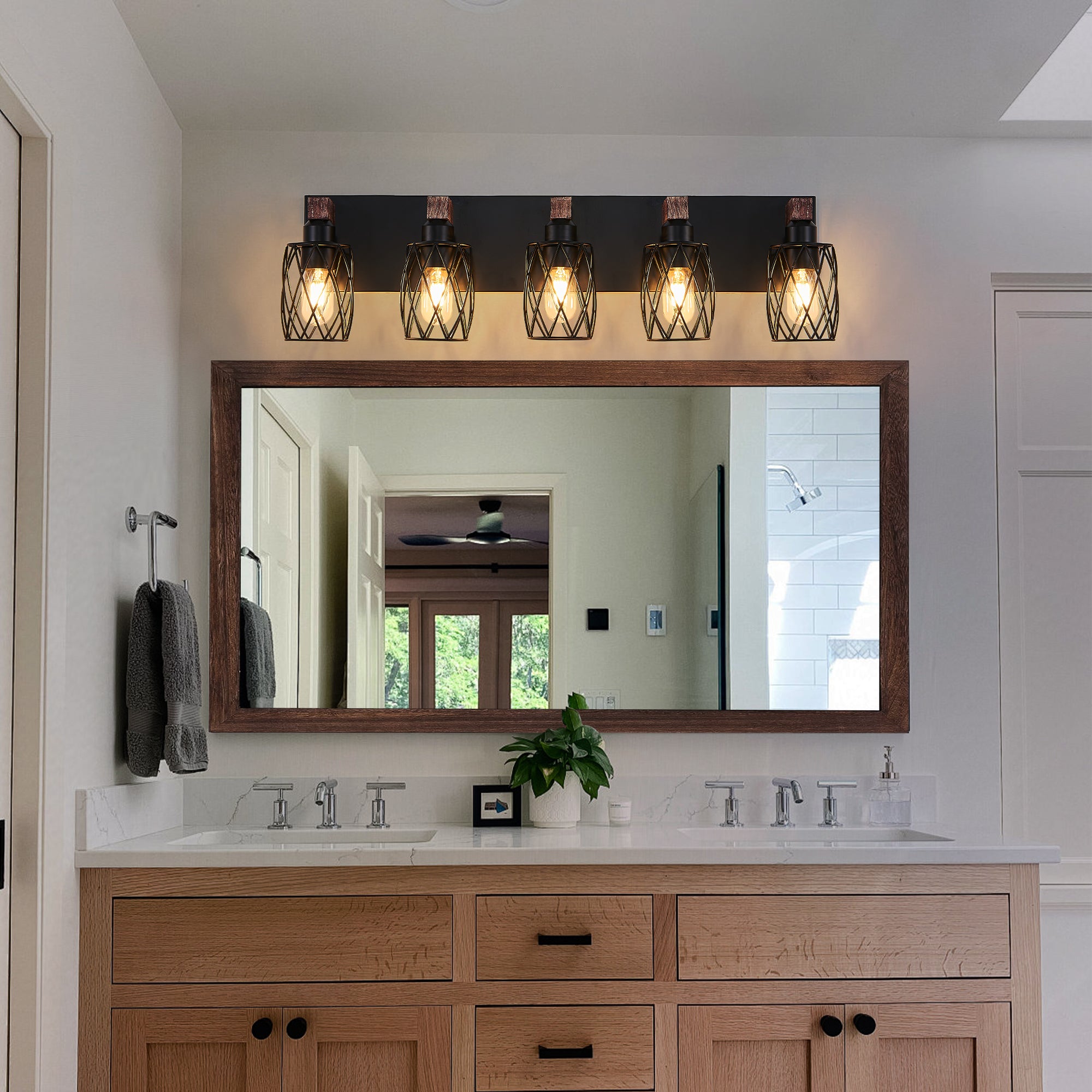 Industrial 5 light wall sconce installed above bathroom mirror